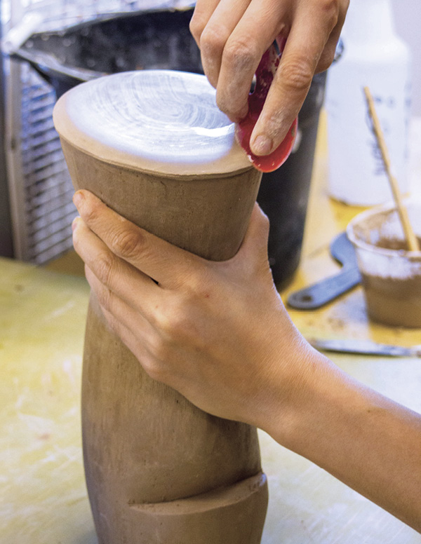 13 Add a soft leather-hard slab as the bottom and compress with a flexible rubber rib.