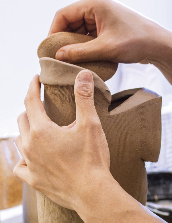 15 Start easing the coil outward with a sponge to define the spout.