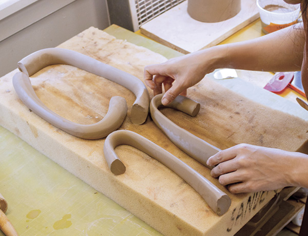 17 Once pulled, shape the handles into arcs and lay them flat on foam to set up.