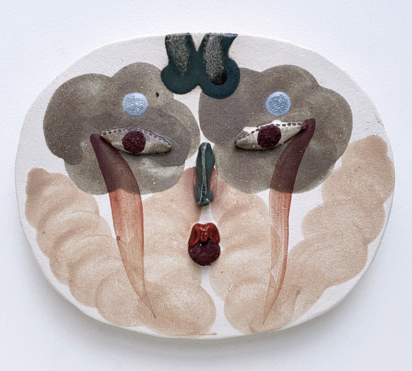2 Face relief from the Slow, silly, go! series, 7⅞ in. (20 cm) in diameter, stoneware, stained slips, 2024.