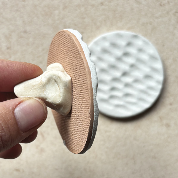 3 The putty firmly holds the ornament and is easily removed after glazing.