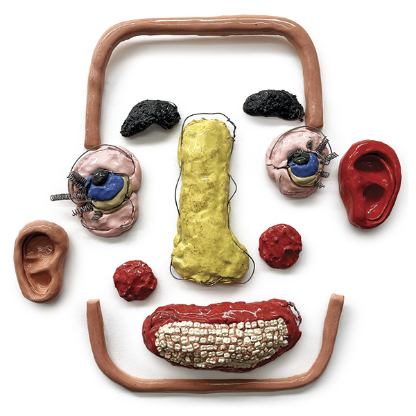 Reilly Deller’s Smile Like A Pretty Girl, 3 ft. (91.4 cm) in height, colored stoneware, glaze, fired in oxidation, Nichrome wire, patronizing commentary, porcelain molars, 2026.
