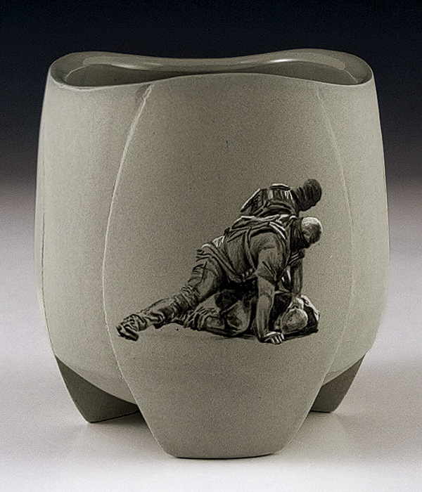 1 Juan Barroso’s Immigrant Narrative Cup, 4 in. (10.16 cm) in height, slip-cast porcelain, underglaze, glaze, fired to cone 6, 2026.