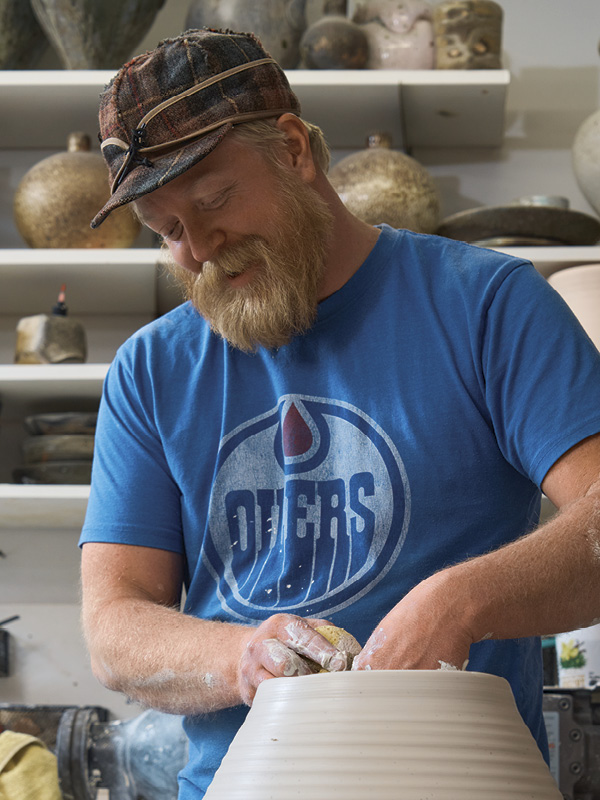 2 Haas throwing a vessel in his home studio.