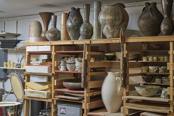 7 A glimpse into Haas’ studio space where shelves are stacked with finished work and works in progress.