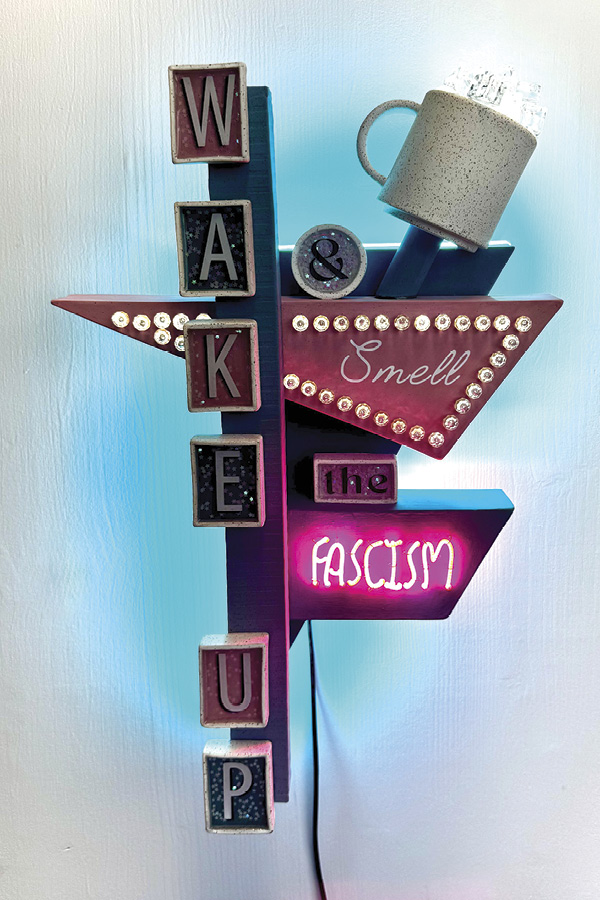 3 Kate Schroeder’s Wake Up And Smell The Fascism, 18 in. (45.7 cm) in height, stoneware, underglaze, nichrome, LED, resin, glitter, 2026.