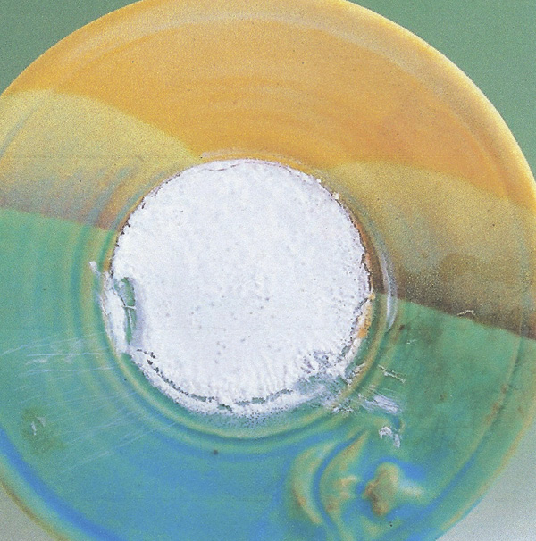 5 High concentration (white powder) of soluble salts precipitated out of fired glaze.