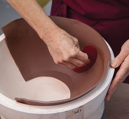 4 Press the cut slab into the mold, slowly expanding it to match the curve.