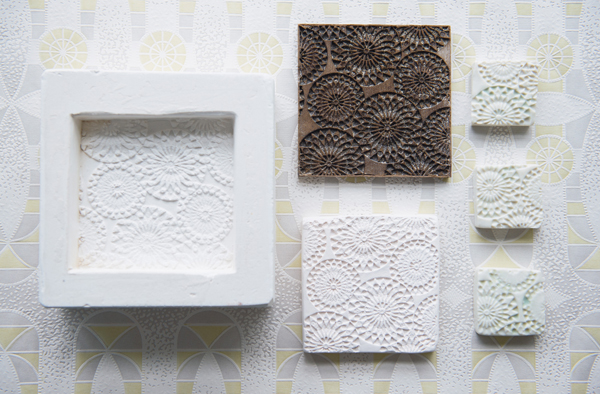 Jazz tile production process (counter clockwise from top center): laser-cut wood positive model; one-part plaster mold; hand-pressed, porcelain bisque-fired tile taken from the mold; three hand-pressed porcelain test tiles, fired in an electric kiln to cone 10, 2016.