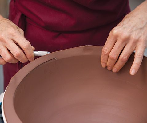 5 Trim the top using a modified knife that allows the blade to be held flush with the top of the mold.