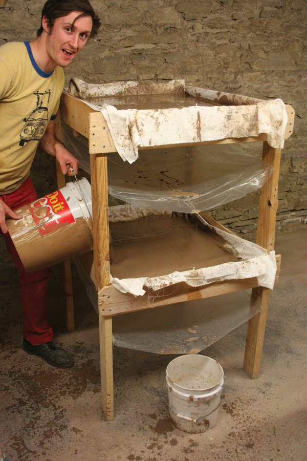 2 Henry Crissman pouring slip into his gravity filter press.