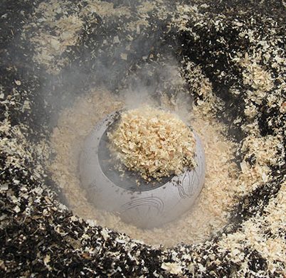 6 Fill the smoking chamber with wood chips to induce reduction.