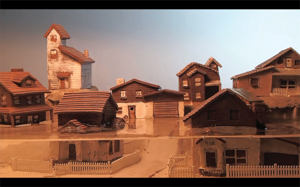 Jonah Amadeus Skurky-Thomas’ The Collapse/Childhood Home, video, clay, water, 2014.