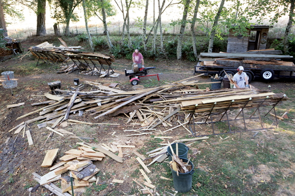 2 Jesse Jones and Chris Pate loading and cutting wood, using the X-frame racks.