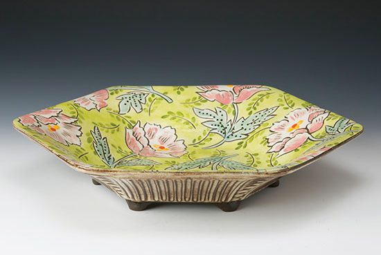 The finished peony pattern plate, showing the raised feet and carved pattern accentuated with tin white glaze. Photo: ARC Photographic Images.