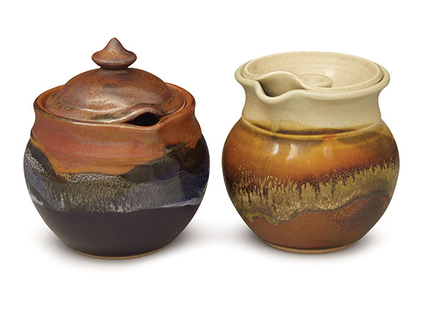 Two variations of the honey pot, fired and glazed. Both are made with stoneware and fired to cone 6 in a reduction atmosphere.