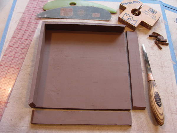 1 Construct the trays by rolling out slabs by hand so the clay is compressed and dense.