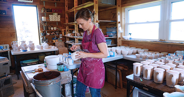 Julie Crosby in the studio glazing. Photo: Marilyn Rivchin.