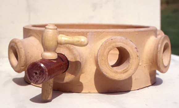 A fired ring with a spigot inserted into its proper hole. The corresponding cork used as the gauge for this hole will be used when throwing.