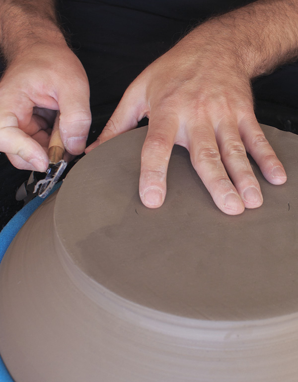 12 Trim the foot of the leather-hard bowl to shape the curve, matching the interior.