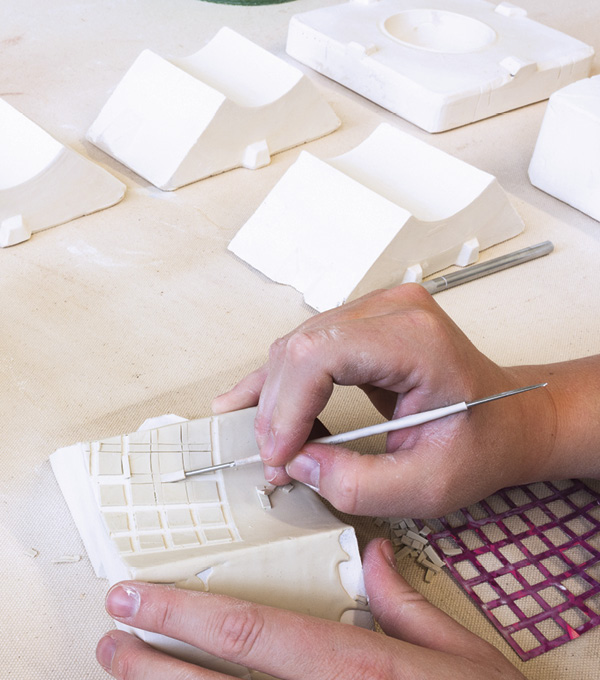 2 Once the vinyl is removed, a detail tool is used to pick out the pattern exposing the plaster face of the mold.