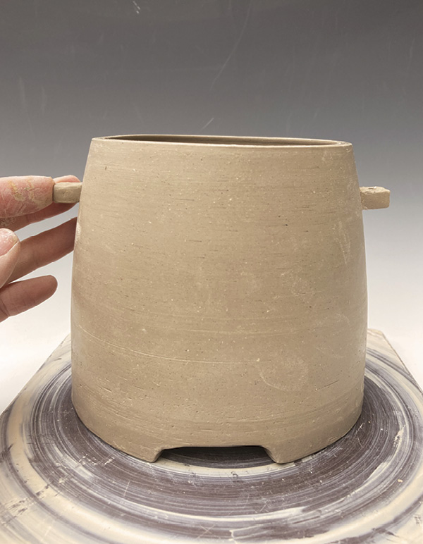 13 Position the lugs to be centered between two feet and at a height that suits the pot.