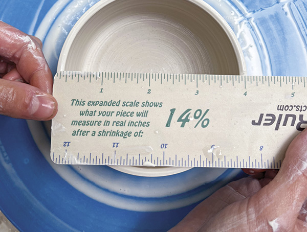 A Use a shrinkage ruler to measure the diameter of the mug warmer from outside rim to outside rim.