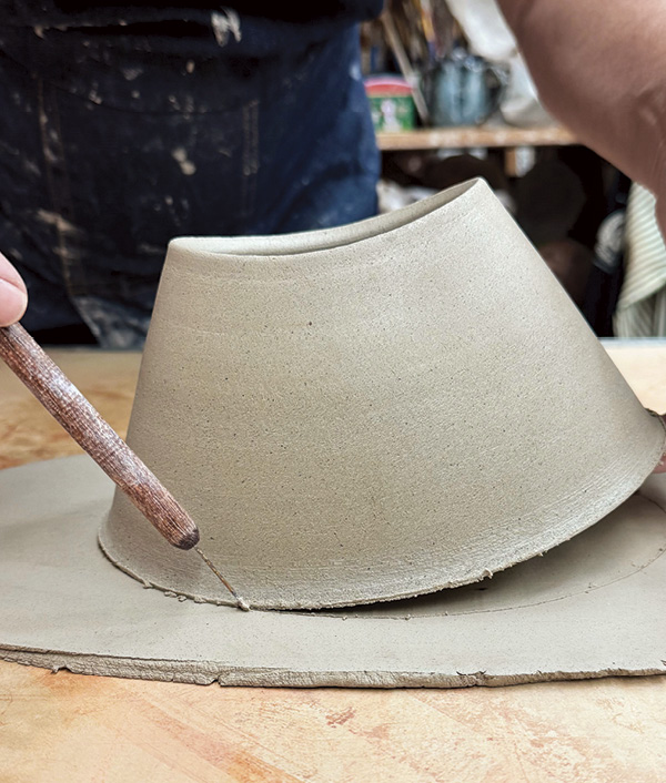 9 Roll out a slab for the bottom and mark the edge of the oval by rocking and tracing the edge.