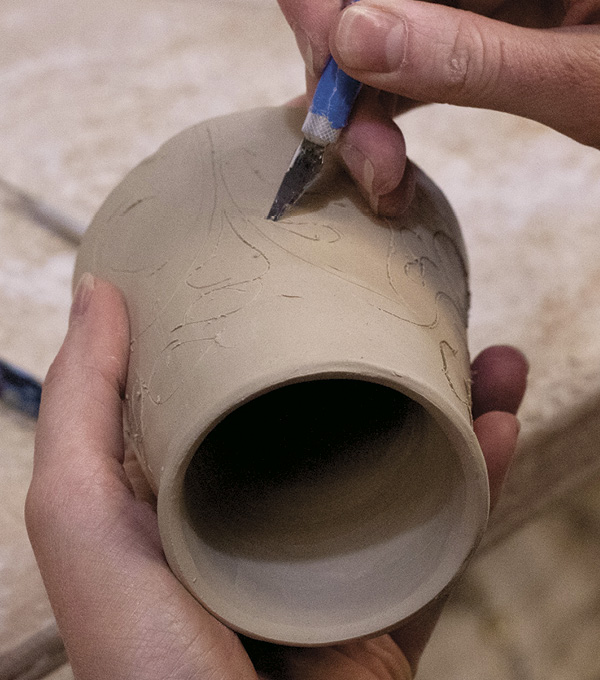 2 Use an X-Acto knife to carve through the outer wall. Guide the blade deep enough to only pierce the outer layer.