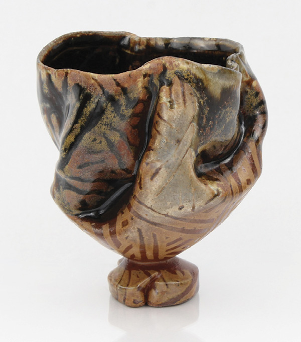 6 The fired cup has a hydro-dipped glaze in a woven pattern and was fired in reduction to cone 10 in a soda kiln.