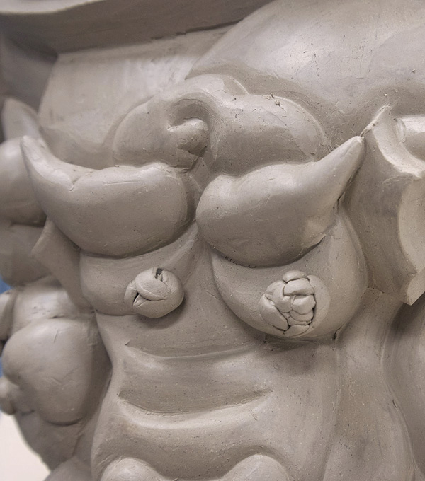 5 Finish adding coils and rough trimming. Let the work dry until leather hard, then start a final trimming and refine edges.