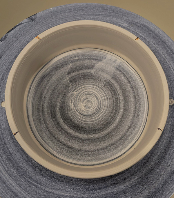 1 Throw a bottomless ring. Once firm, mark the top at four points so one section is larger and cut through the marks.