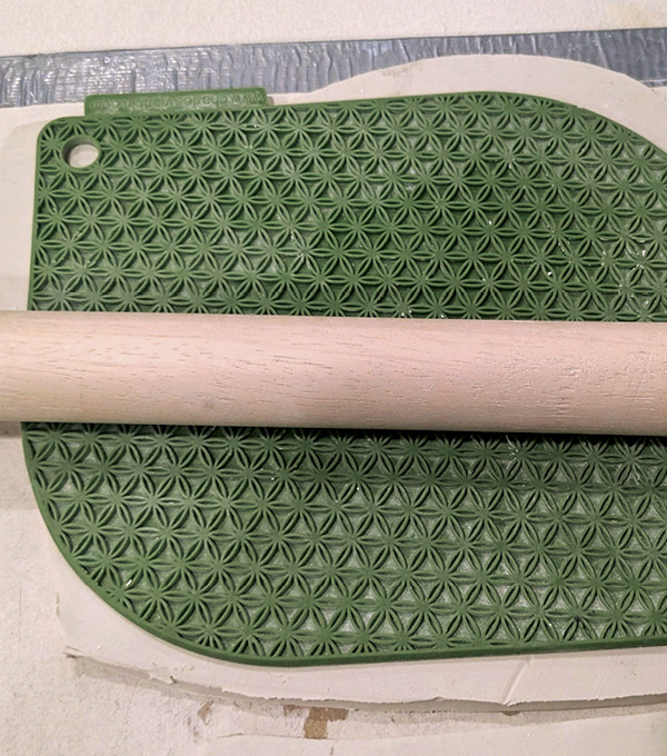 3 Roll out two slabs large enough to fit the full size of the frame. Add texture to both slabs.