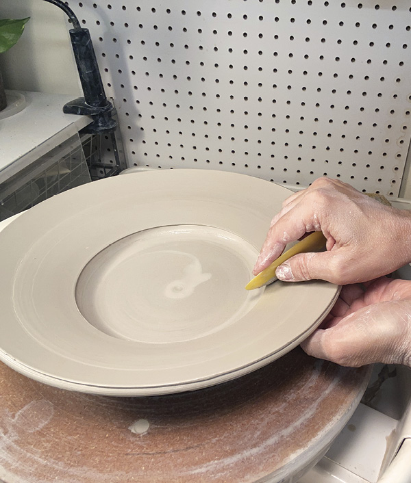 9 While supporting the under side, push the rim to its final angle.