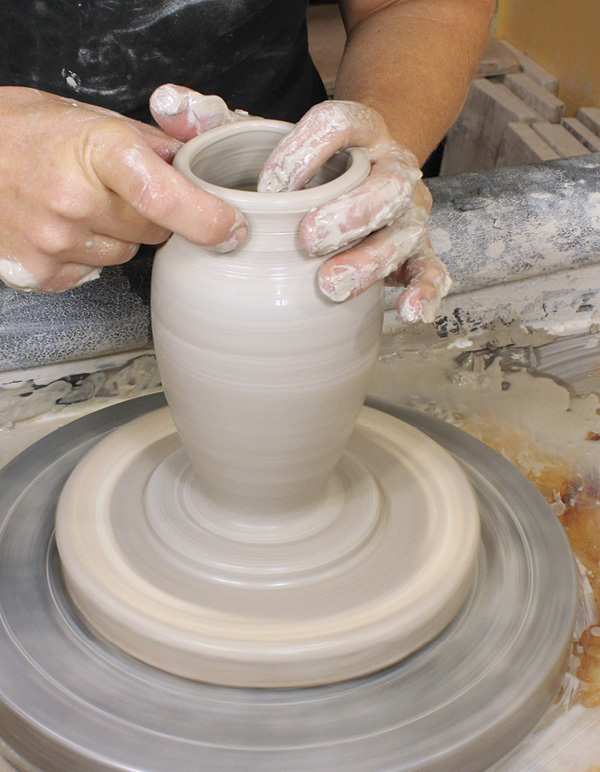 3 Collar the form about 2 inches (5 cm) below rim. Use even inward pressure.