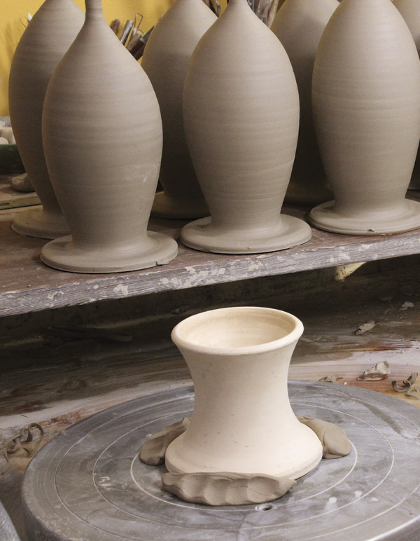 8 Center a chuck on the wheel and secure it with clay lugs.