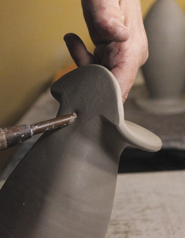 13 Smooth and shape the neck. Cut a hole at an upward angle for hanging.