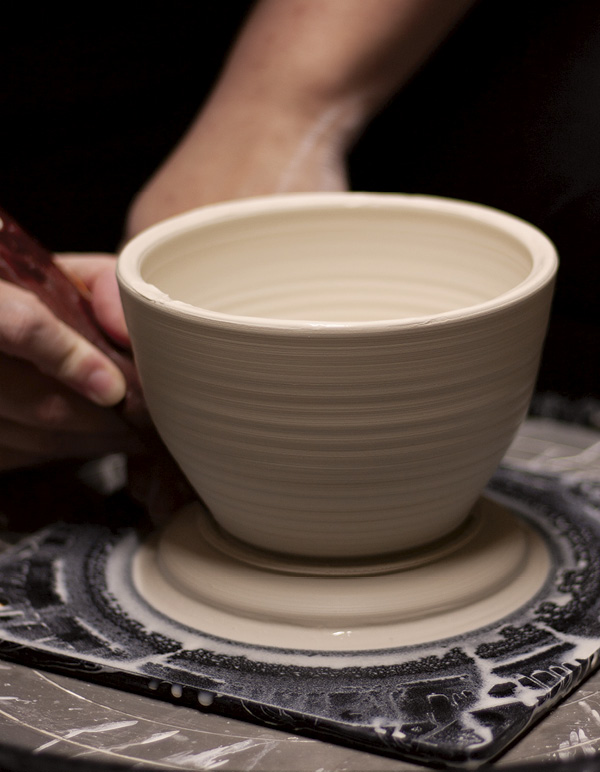 2 Pull the walls up, cut off excess clay at the base, and remove throwing lines.