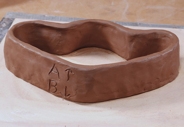 1 Coil or slab build a drop mold in the shape of your candelabra body. Designate A and B sides on the mold.