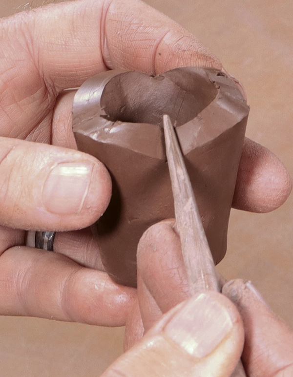 12 Alter rims of the candle cups. Compress any knife cuts to prevent cracking.