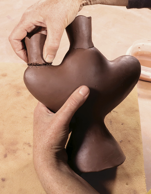 13 Attach the scored candle cups to the hollow form.