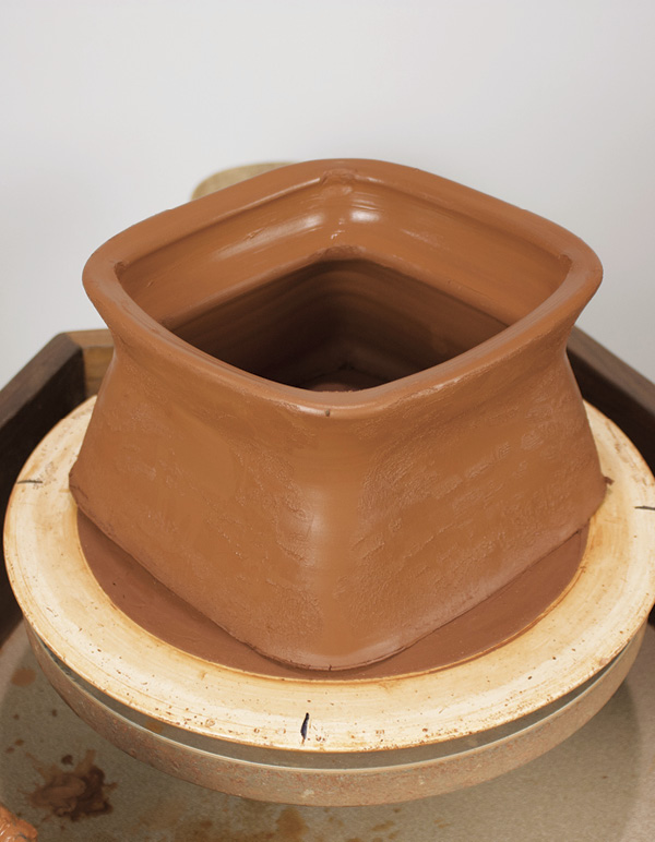 2 Cut cylinder off the bat and use fingers to pull into a rough square shape.