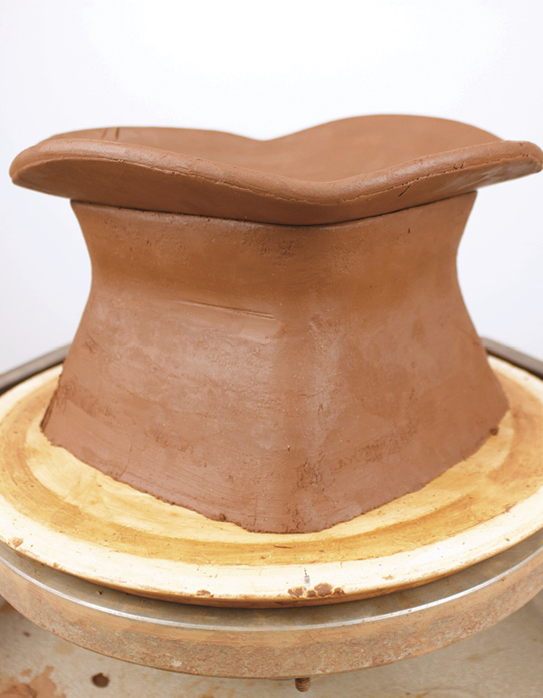 6 Slump the second slab into the squared cylinder to form the top of the box.