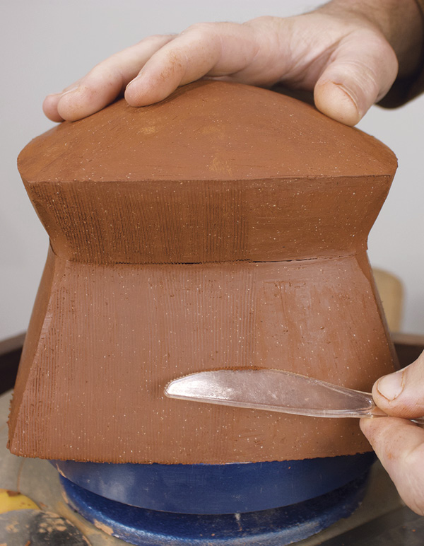 14 Use a plastic knife to make textured marks on each panel of the box.