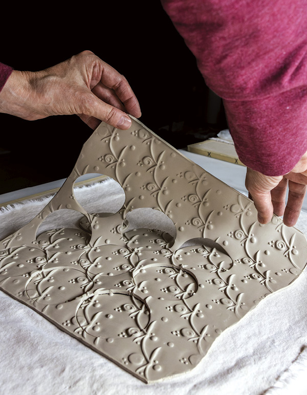 3 Remove the excess clay from around the cut circles.