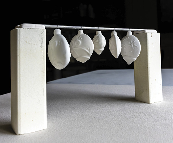 16 Hang ornaments on a bead bar supported by two kiln posts. This keeps the pieces from sticking to the shelf during firing.