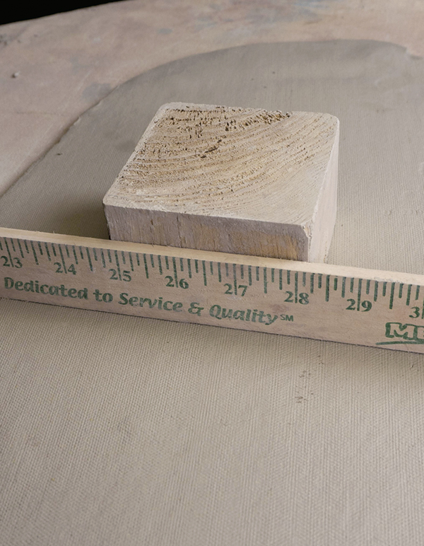 1 Box form cut from a 4x4-inch wooden post with a clay slab and a ruler.