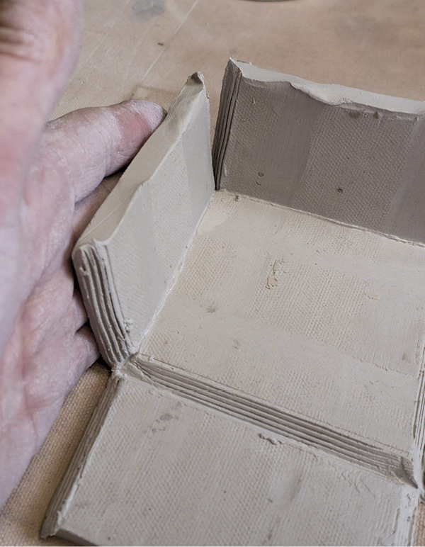 8 Score, slip, and fold the sides of the box up using your hand or a wooden board.