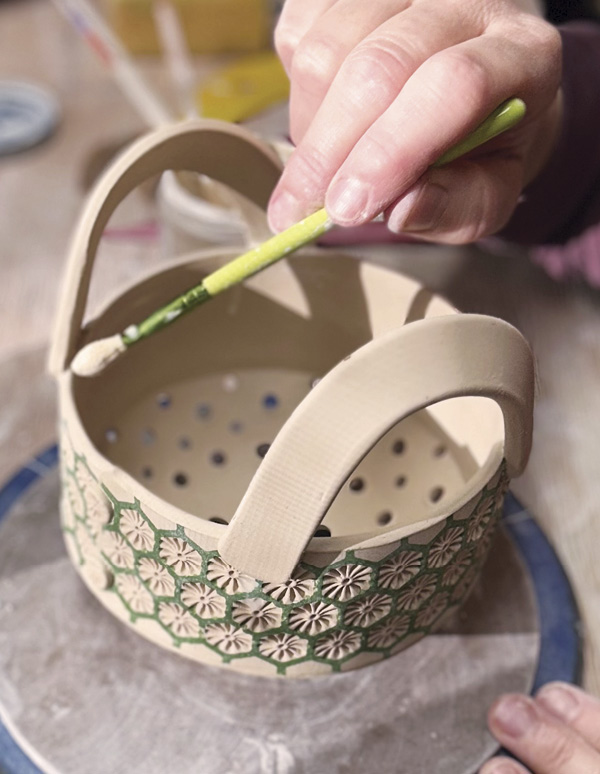 14 Evenly space handles across from each other on the bowl, attach, and smooth.