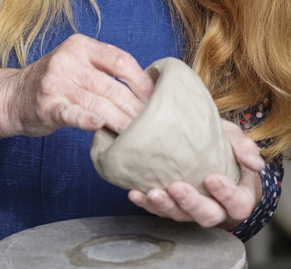 Example of using hands as a tool in forming clay.